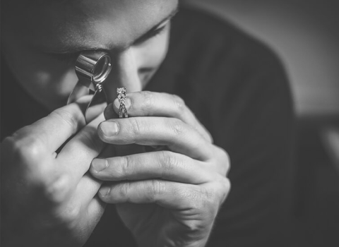 Gemologist looking at an engagement ring