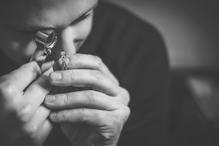 Gemologist looking at an engagement ring