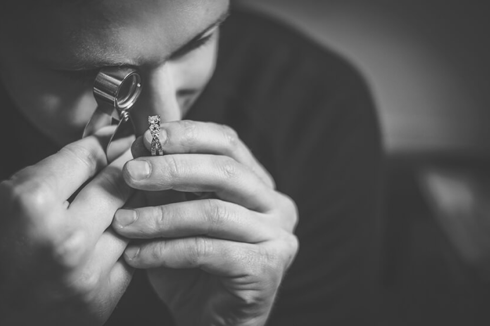 Gemologist looking at an engagement ring